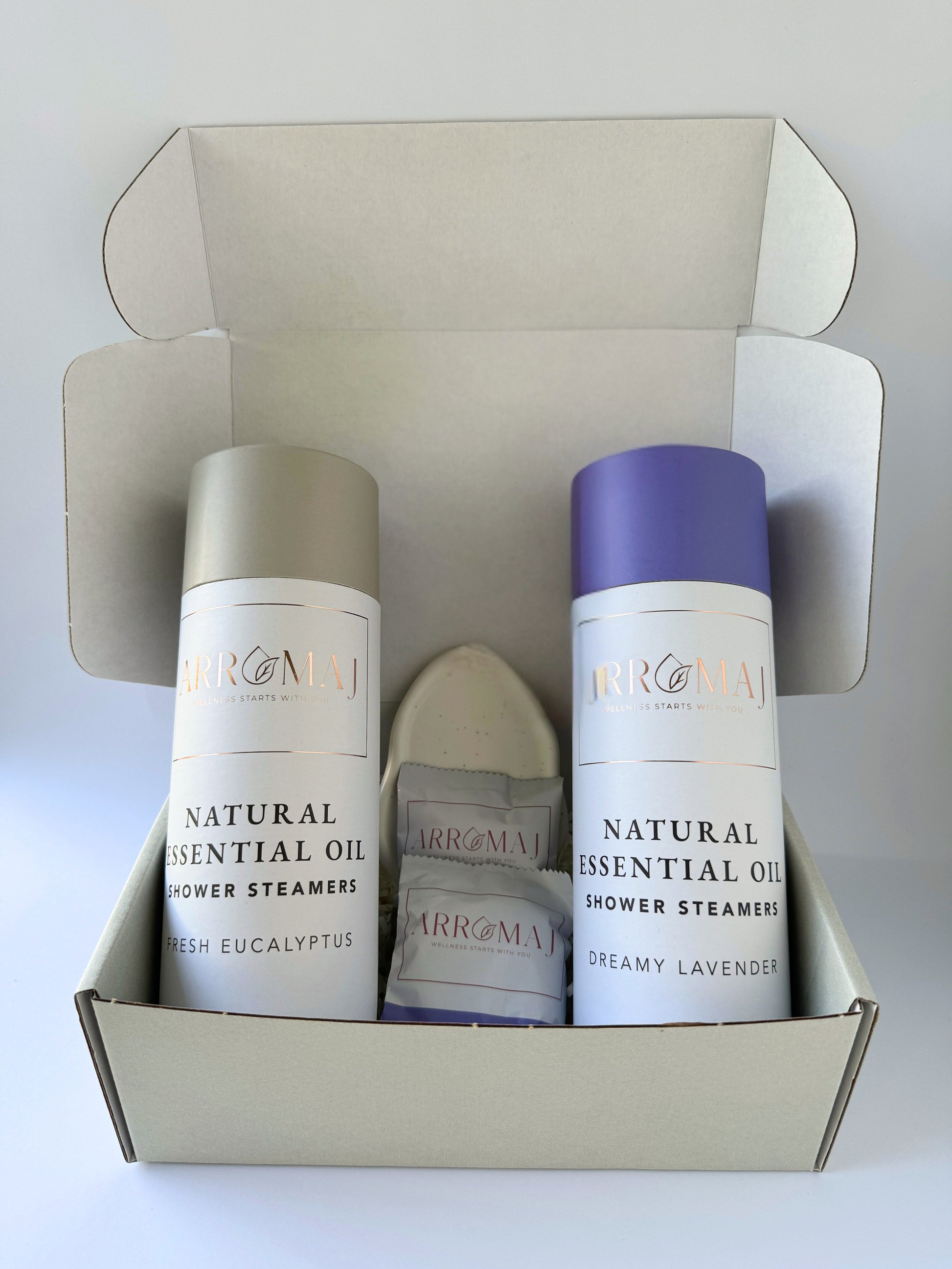 1 natural lavender essential oil shower steamer canister, 1 eucalyptus essential oil shower steamer canister and a steamer dish tray in a gift box